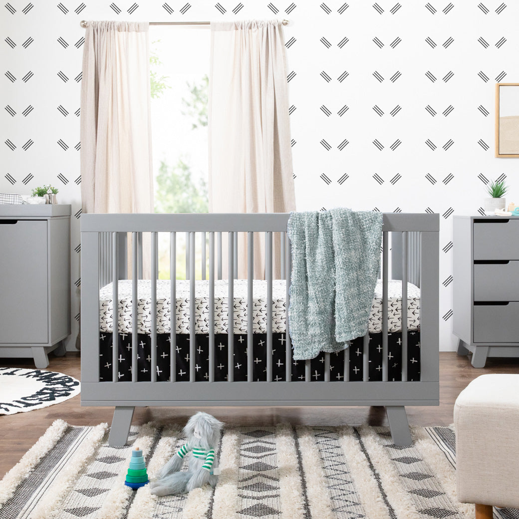 Babyletto Hudson 3-in-1 Crib next to a dresser in -- Color_Grey