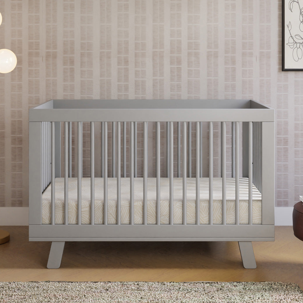 Front view of Babyletto Hudson 3-in-1 Crib next to a lamp and stool  in -- Color_Grey