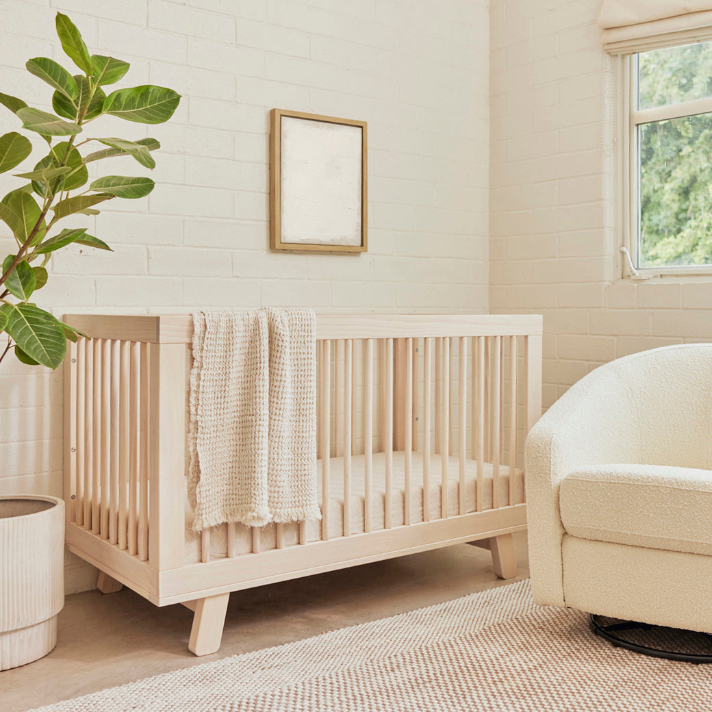 The Babyletto Hudson 3-in-1 Crib with blanket on rail  in -- Color_Washed Natural