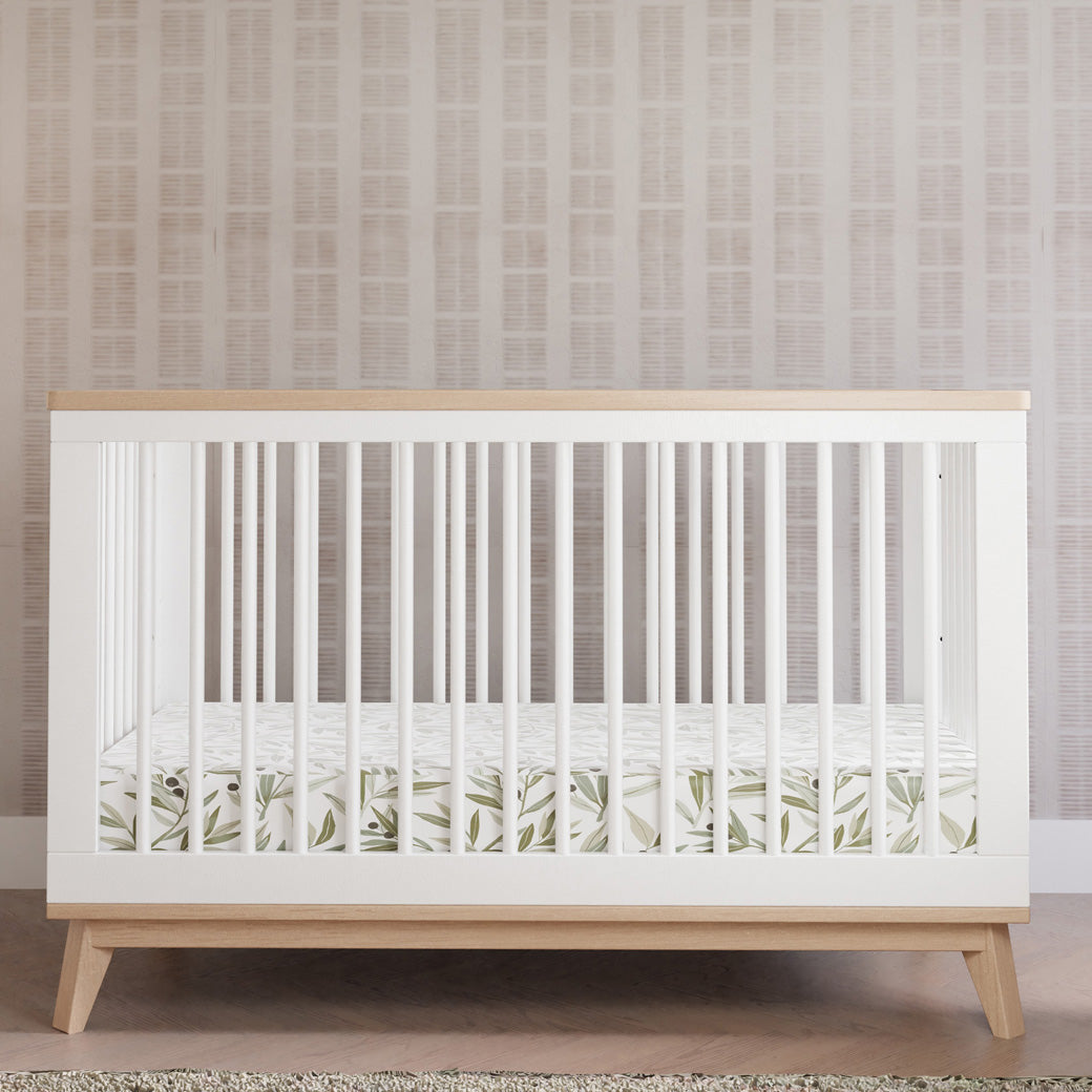 Front view of Babyletto's Scoot 3-in-1 Convertible Crib + Toddler Rail with Babyletto bedding in -- Color_Washed Natural/White