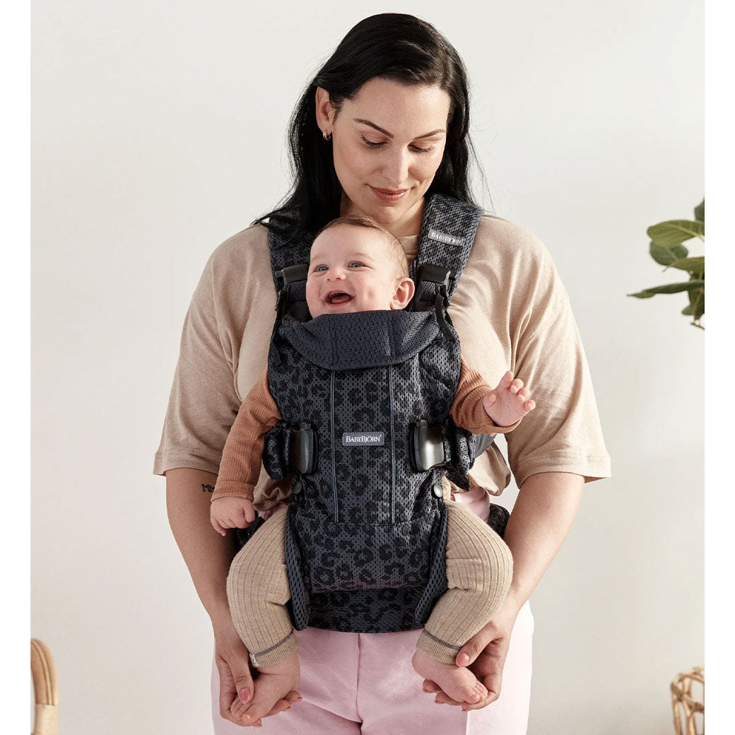 Front view of mom with baby in Babybjorn Baby Carrier One in -- Color_Anthracite Leopard 3D Mesh Air