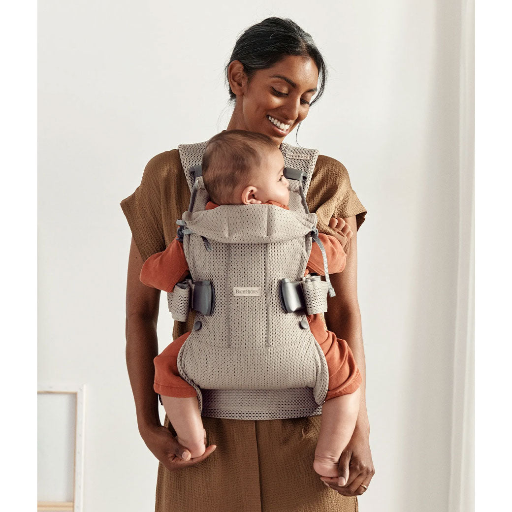 Front view of mom with baby in Babybjorn Baby Carrier One in -- Color_Gray Beige 3D Mesh Air