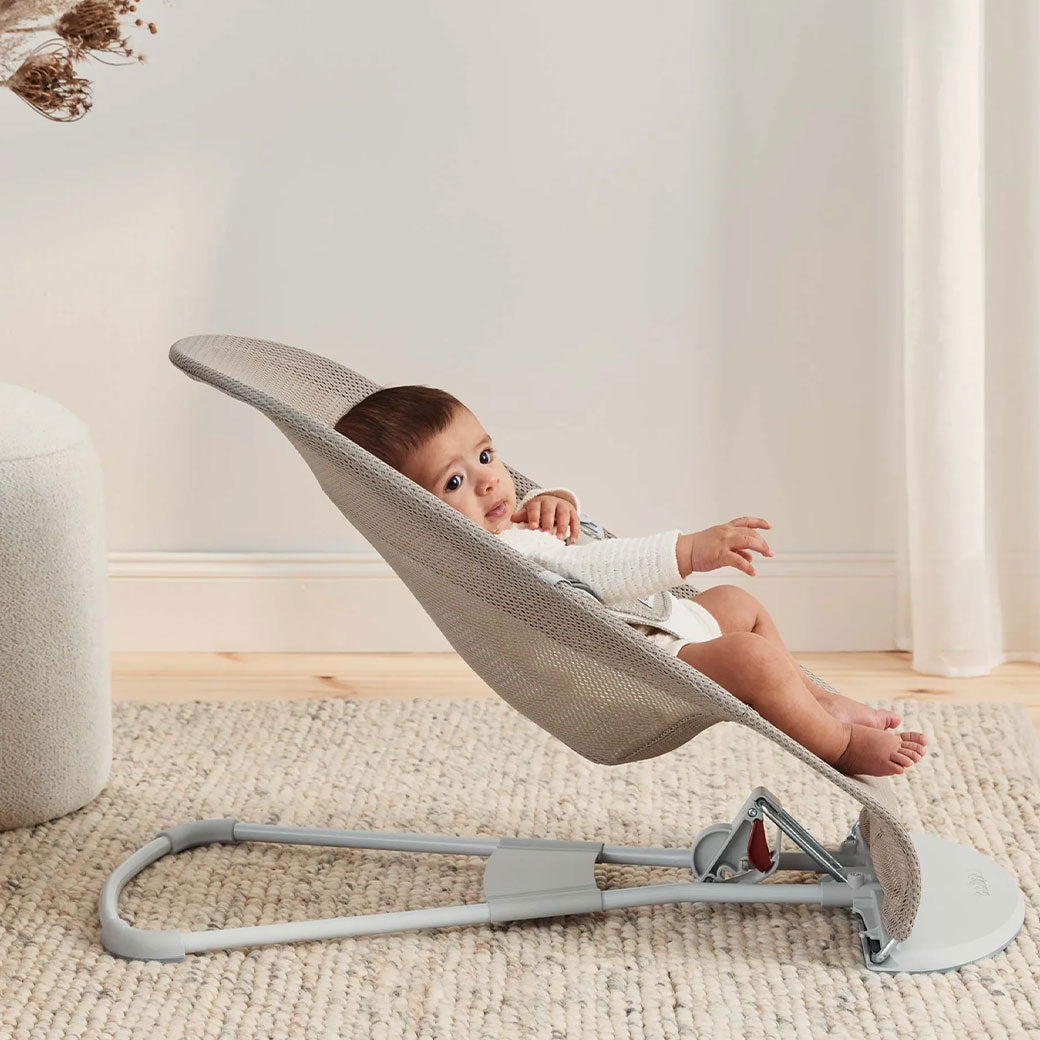 Side view of baby in BABYBJÖRN Bouncer Balance Soft in -- Color_Grey Beige/White Mesh