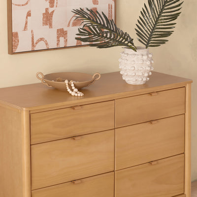 Closeup of the Babyletto Bondi 6-Drawer Dresser with a vase on top  in -- Color_Honey
