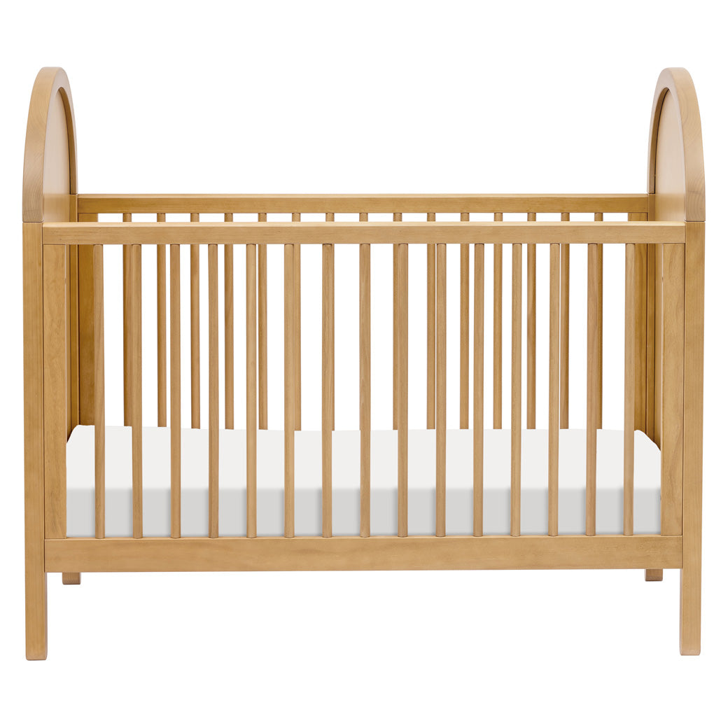 Front view of Babyletto Bondi Cane 3-in-1 Convertible Crib in -- Color_Honey with Natural Cane