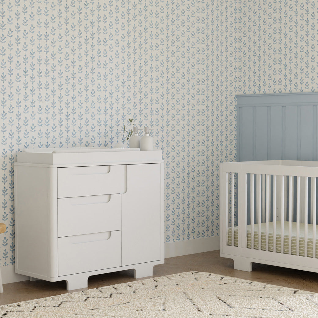 Babyletto Yuzu 3-Drawer Changer Dresser next to a crib in -- Color_White