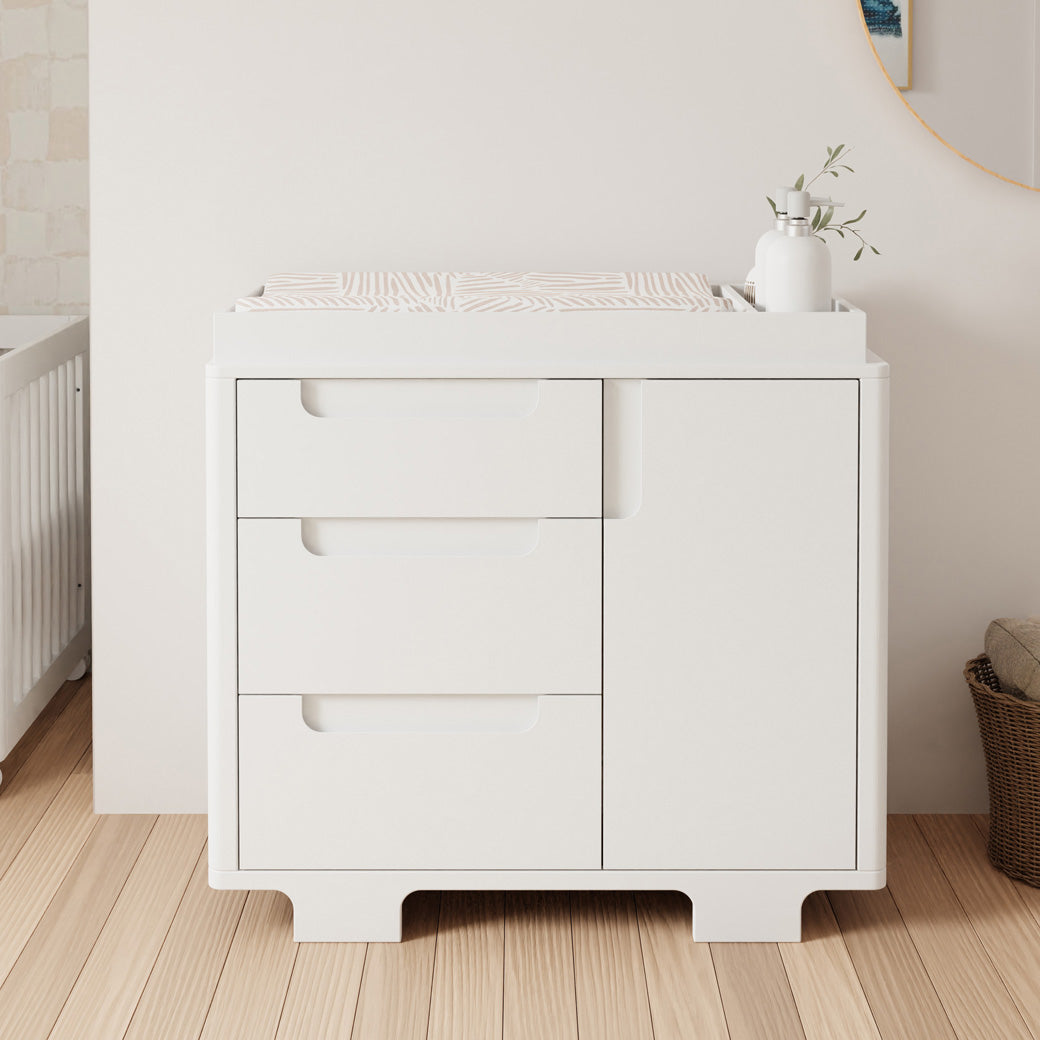 Front view of Babyletto Yuzu 3-Drawer Changer Dresser with tray next to a basket in -- Color_White