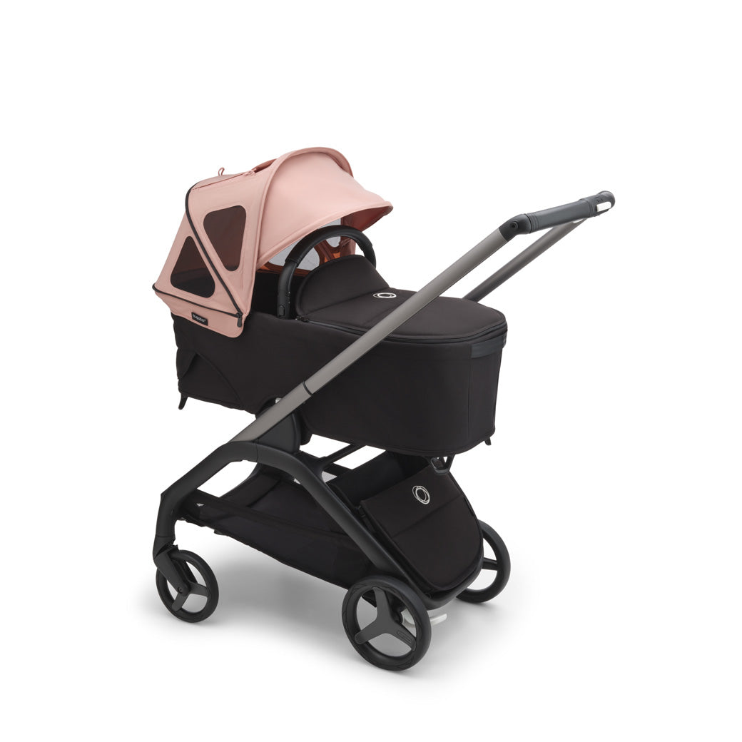 Bugaboo Dragonfly Breezy Sun Canopy on a bassinet spread out in -- Color_Morning Pink