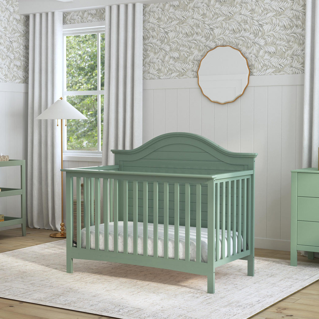 Carter's by DaVinci Nolan 4-in-1 Convertible Crib next to a table changer and dresser  in -- Color_Light Sage