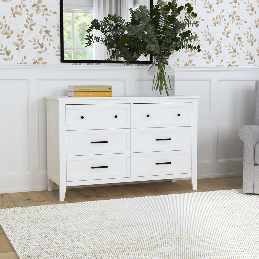 DaVinci Sawyer Farmhouse 6-Drawer Dresser under a mirror with books and plant on top  in -- Color_Heirloom White