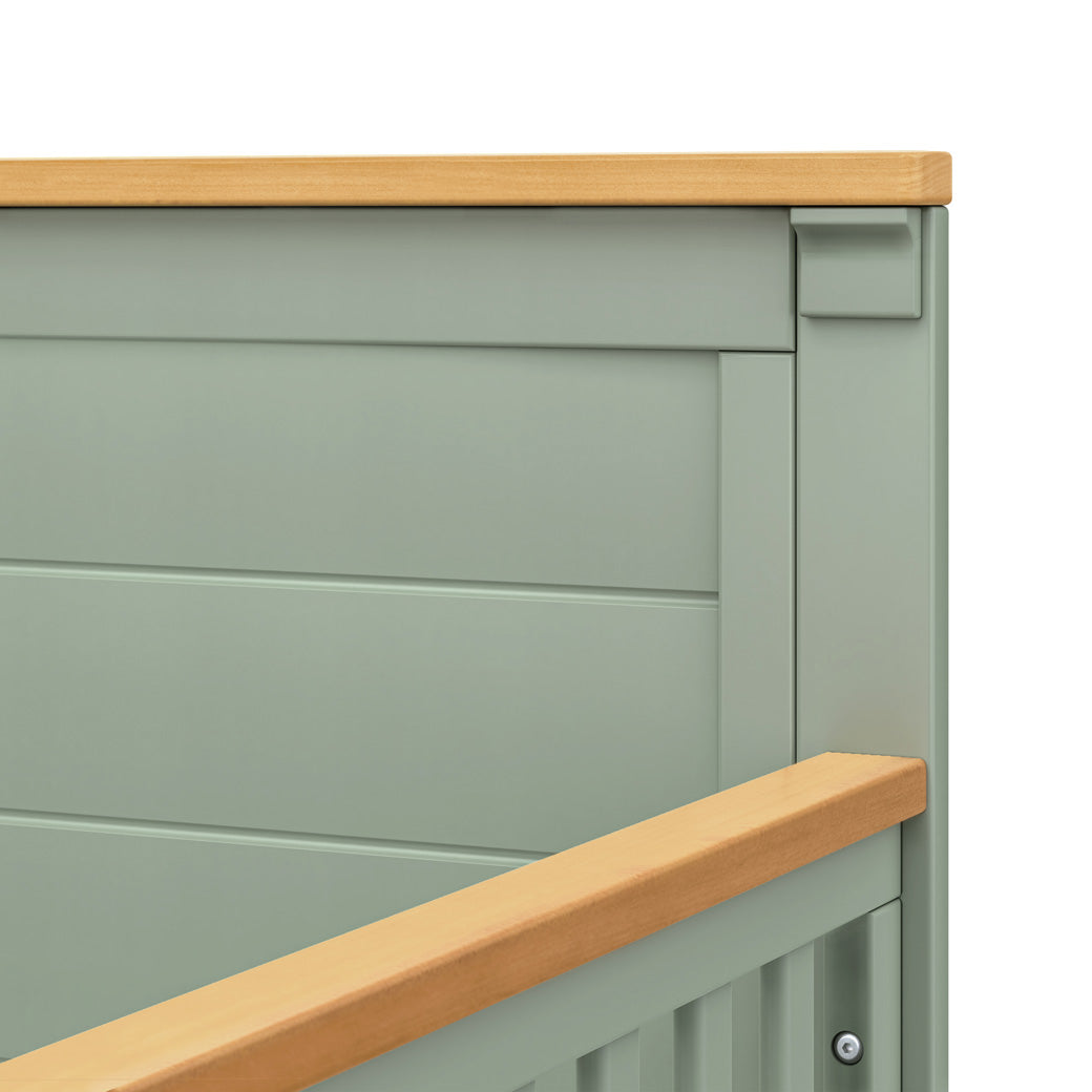 Closeup details of DaVinci Shea 4-in-1 Convertible Crib in -- Color_Light Sage/Honey