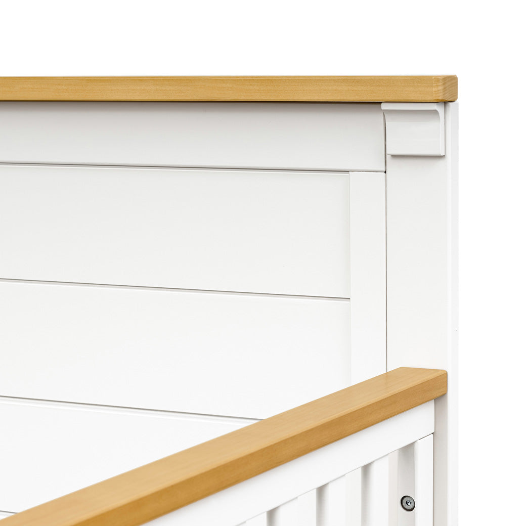 Closeup detail of DaVinci Shea 4-in-1 Convertible Crib in -- Color_Warm White/Honey