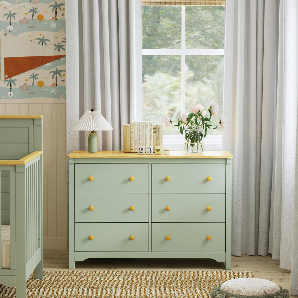 Front view of DaVinci Shea 6-Drawer Dresser next to the Shea Crib in -- Color_Light Sage/Honey