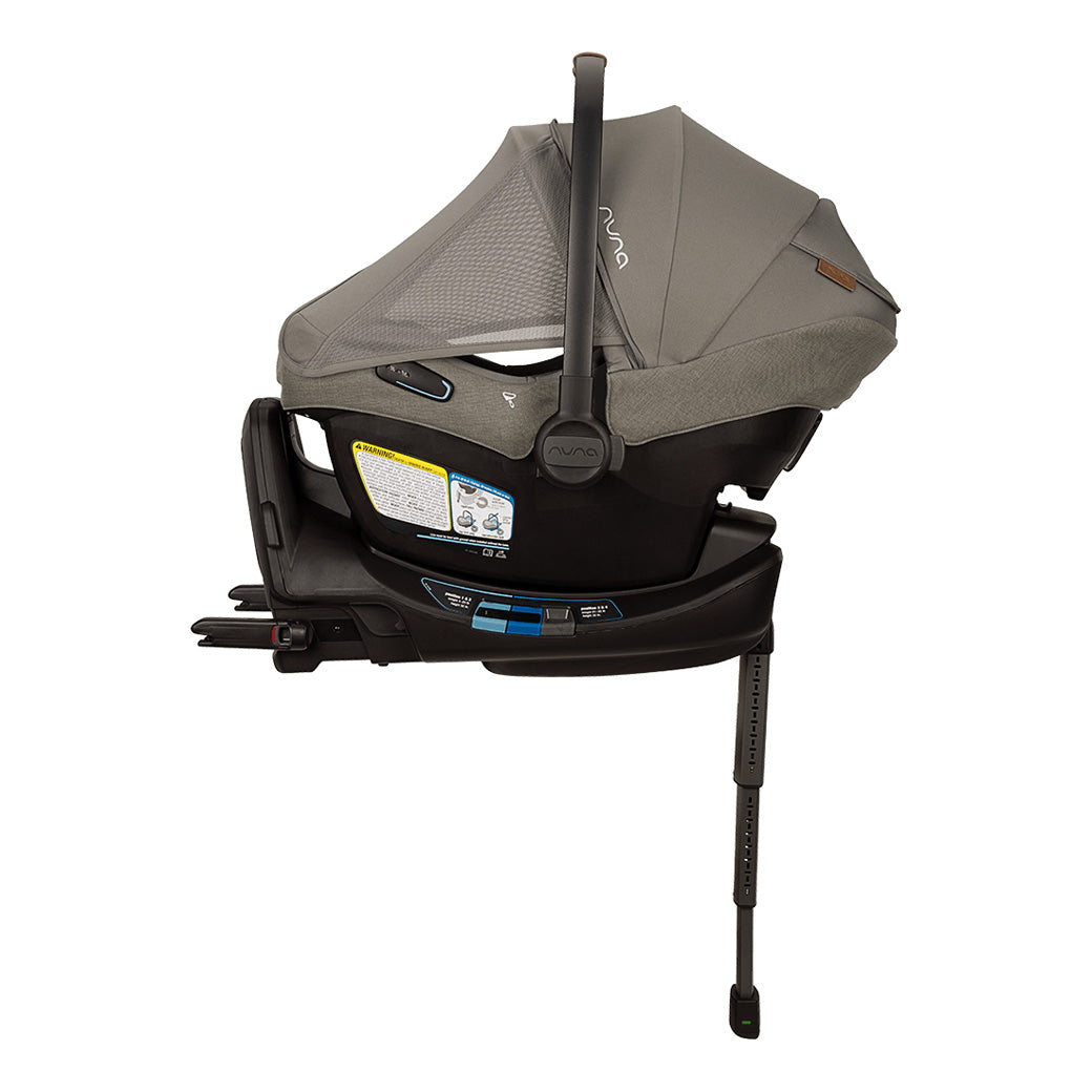 Side view of Nuna PIPA Aire RX Infant Car Seat + PIPA RELX Base with canopy and net down in -- Color_Granite