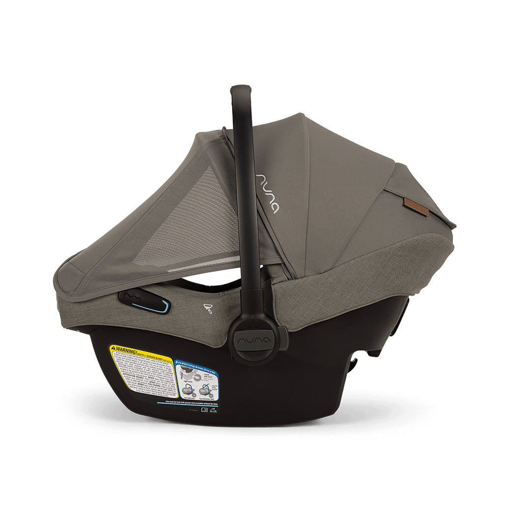 Side view of Nuna PIPA Aire RX Infant Car Seat + PIPA RELX Base without base and with canopy and net down  in -- Color_Granite