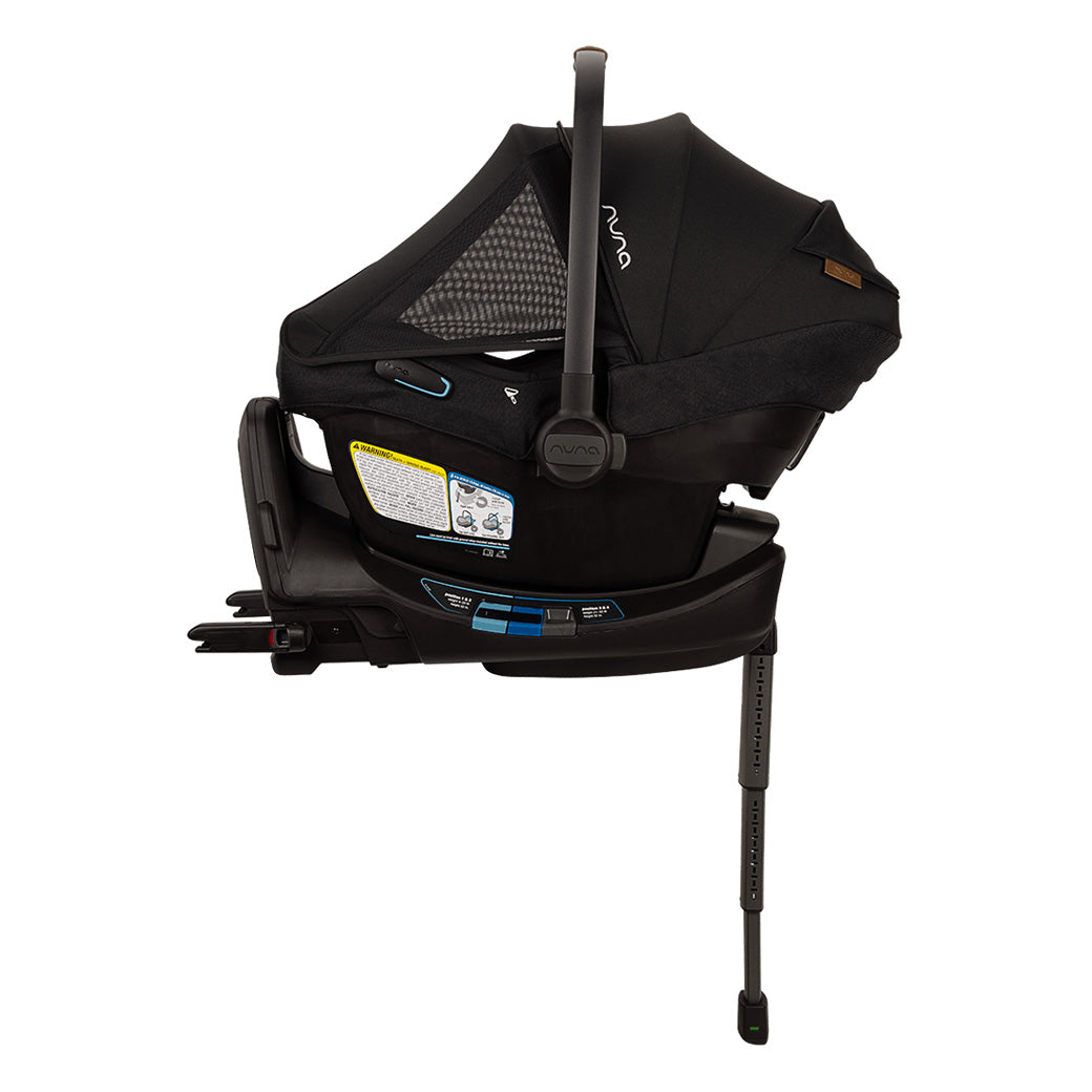 Side view of Nuna PIPA Aire RX Infant Car Seat + PIPA RELX Base with canopy and net down  in -- Color_Caviar