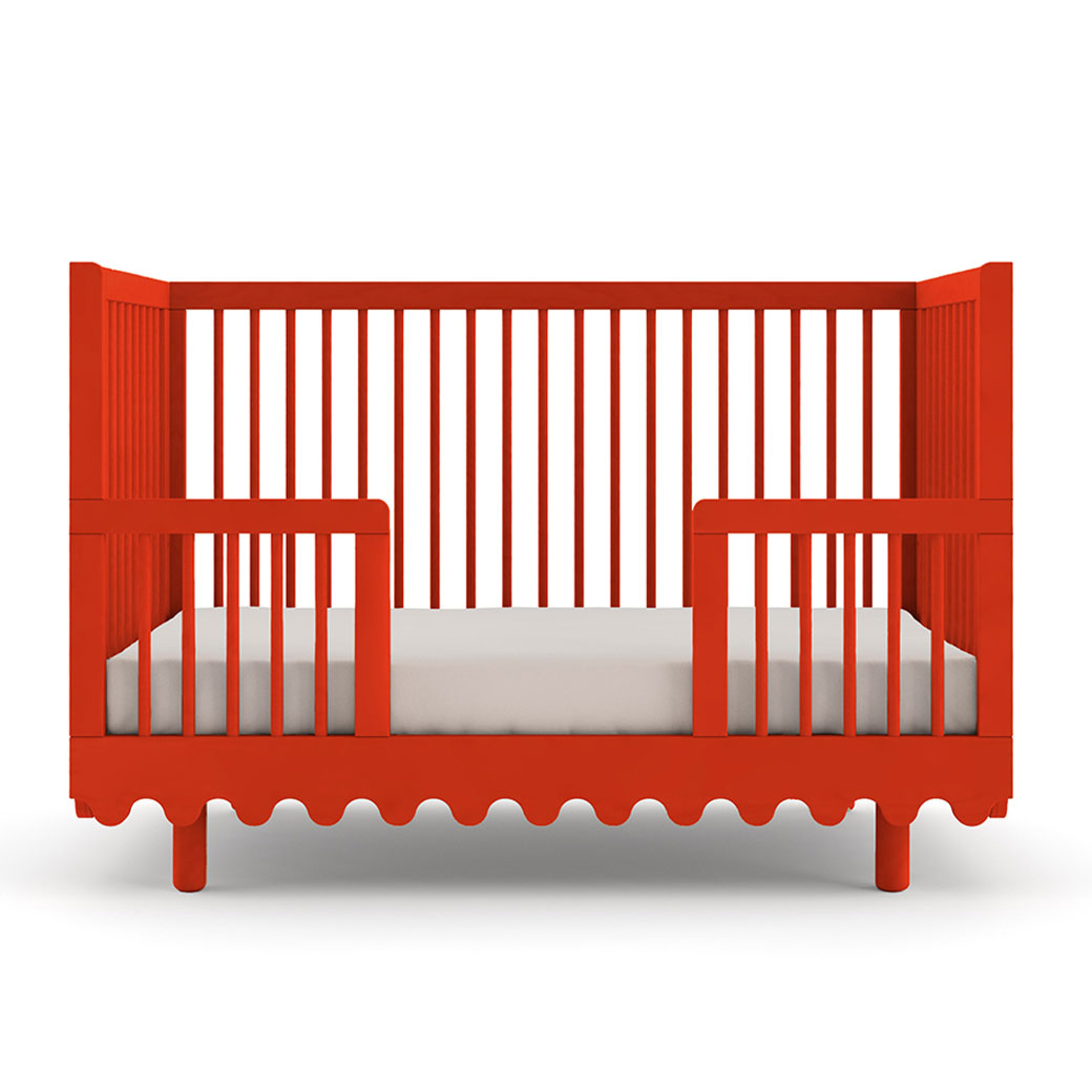 Front view of Oeuf Moss Crib as toddler bed in -- Color_Tomato