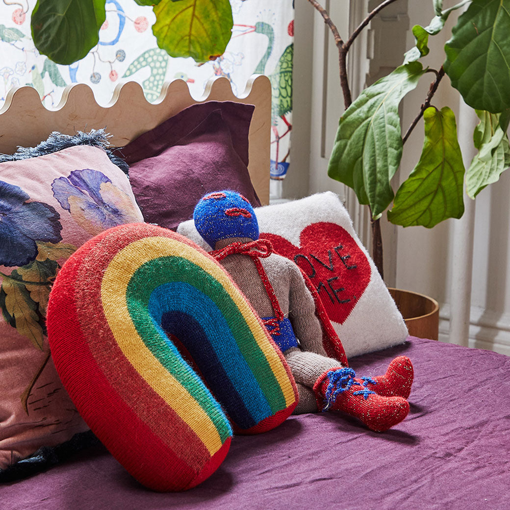 Closeup of pillows and toys on the Oeuf Moss Twin Bed in -- Color_Birch