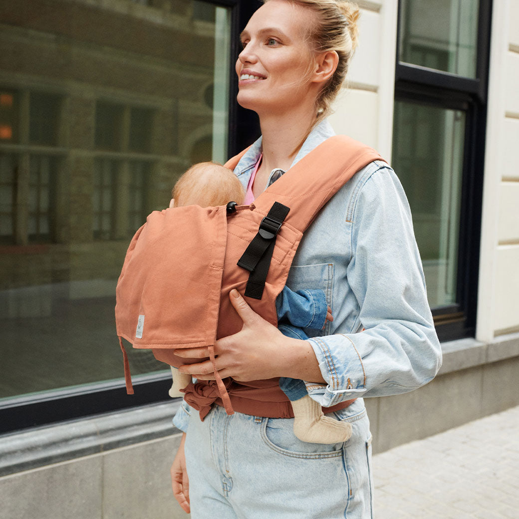 Mom walking with baby in Stokke Limas Carrier Flex in -- Lifestyle