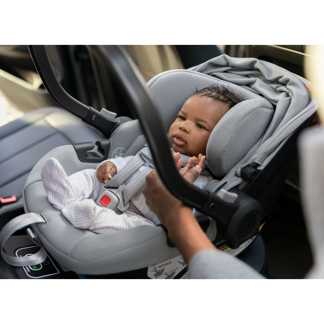 Baby sitting in the Uppababy Aria Infant Car Seat in -- Color_Anthony