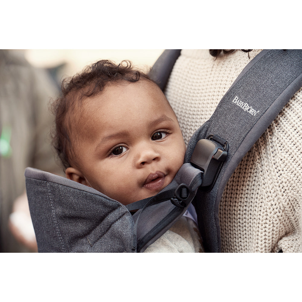 up close image of babies face in BABYBJÖRN Baby Carrier One in -- Color_Denim Gray/Dark Gray Woven Mix