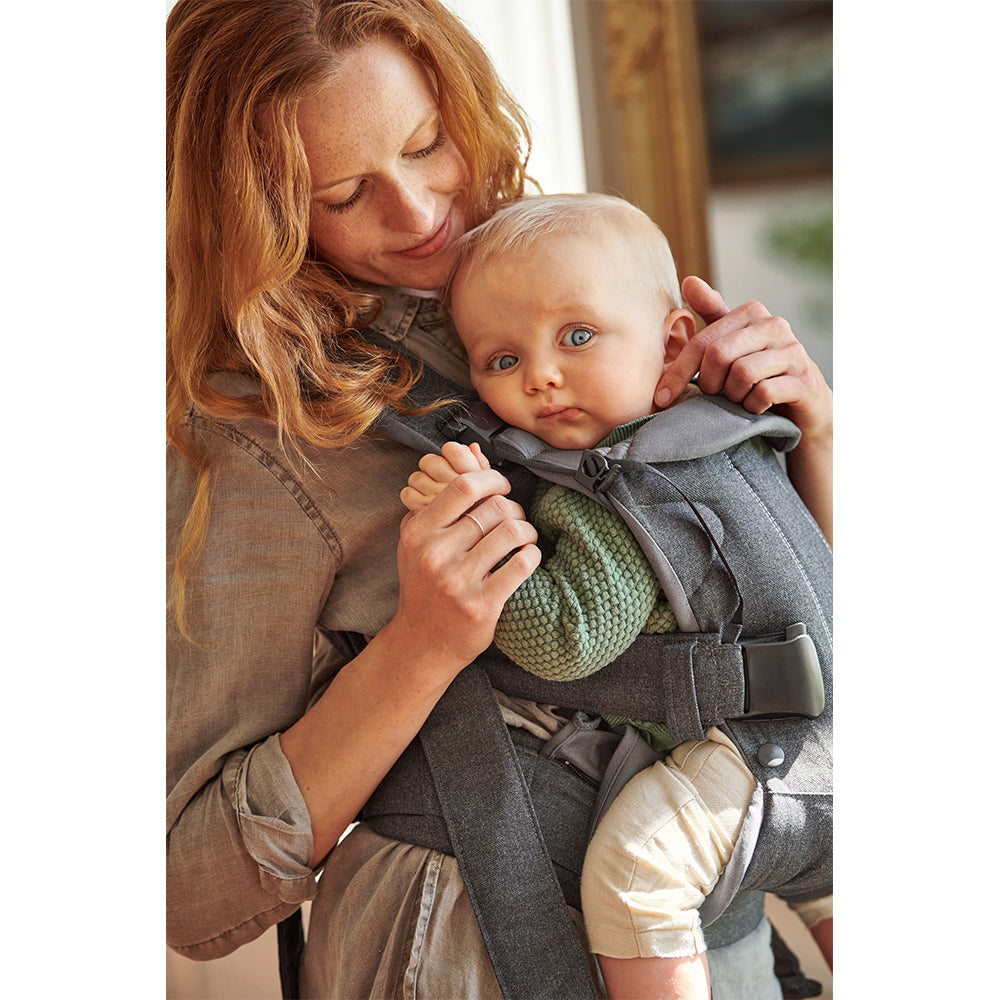 Side view of baby in BABYBJÖRN Baby Carrier One in -- Color_Denim Gray/Dark Gray Woven Mix