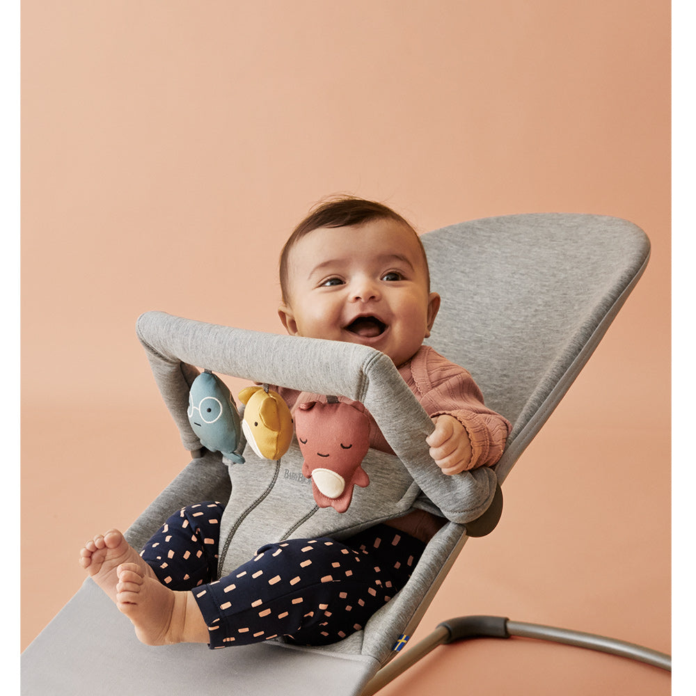 Baby laughing in BABYBJÖRN Bouncer Bliss with toys attached in -- Color_Light Gray 3D Jersey