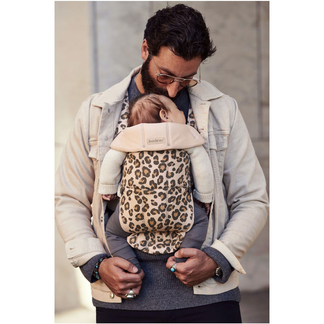 Dad carrying baby in BABYBJÖRN Baby Carrier Mini while baby sleeps in -- Color_Beige Leopard Cotton