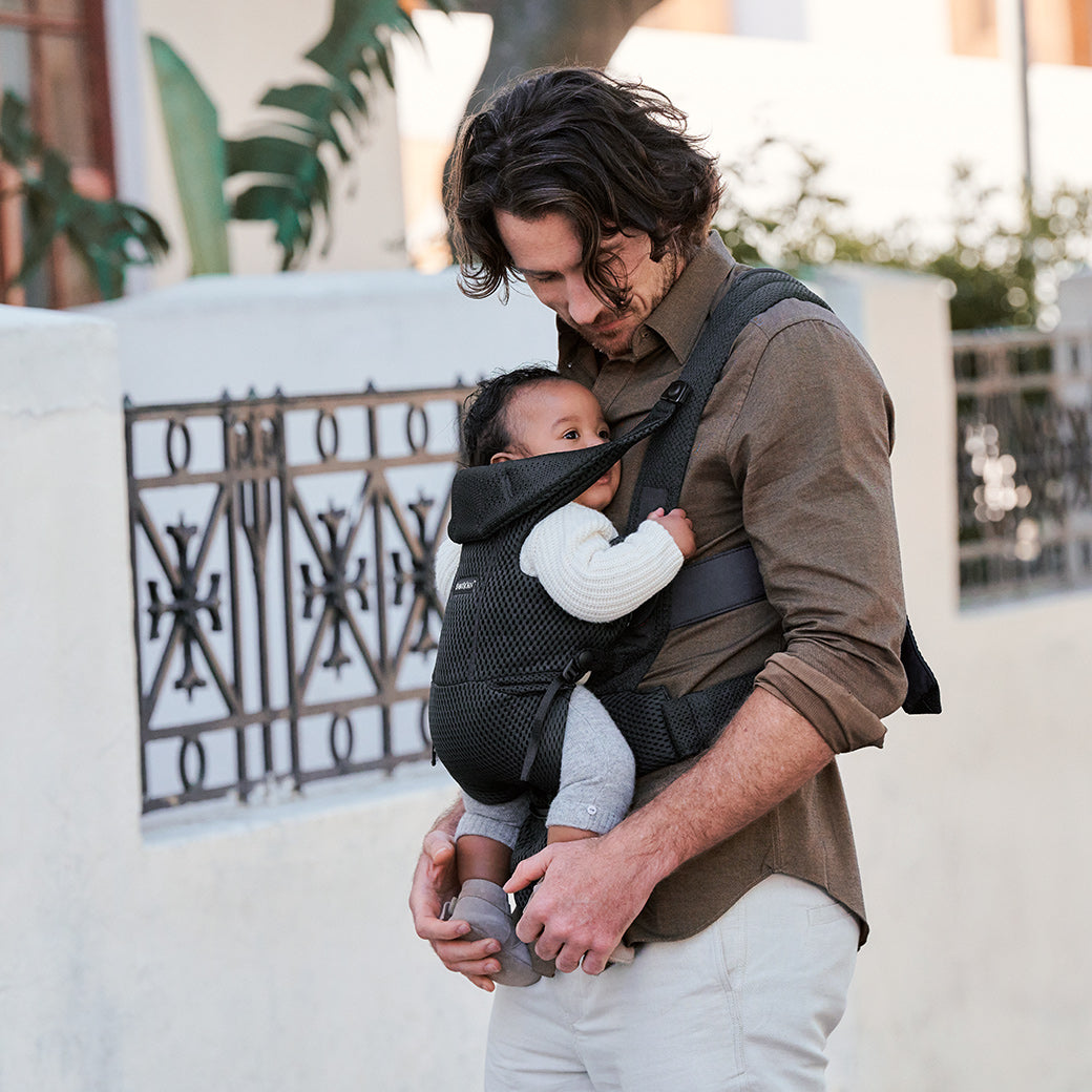 Dad walking with baby in Babybjorn Baby Carrier Free in -- Color_Black 3D Mesh