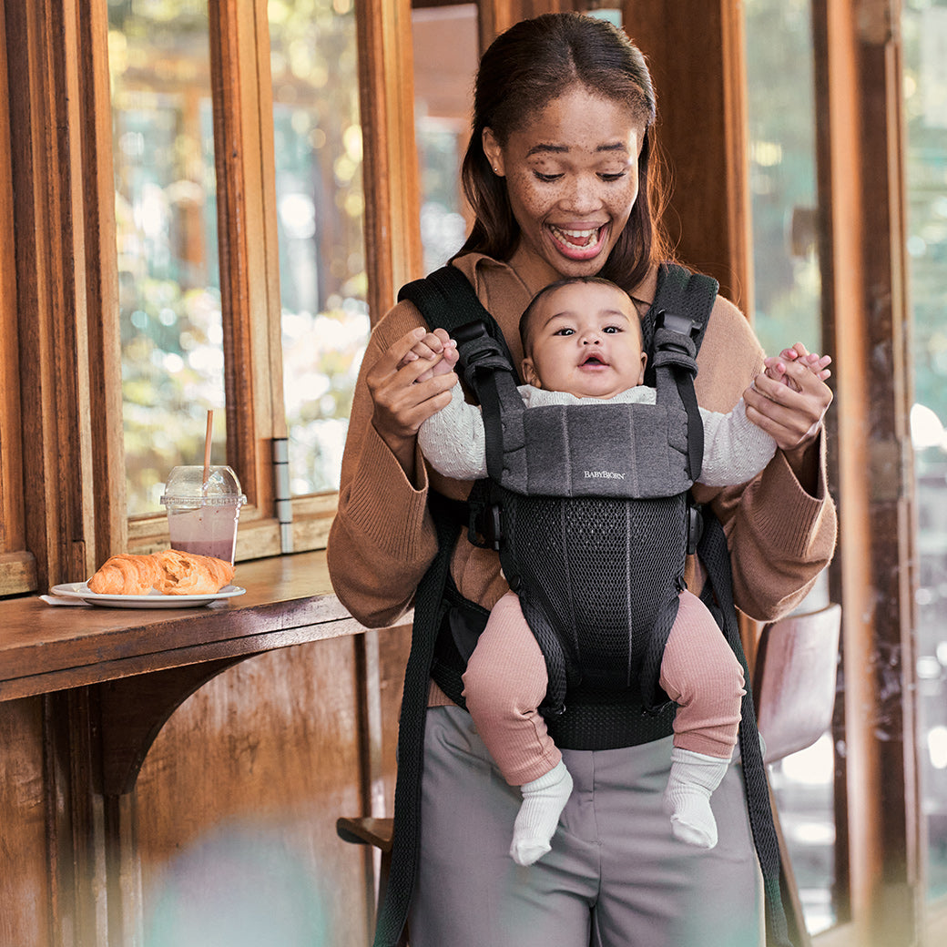 Mom carrying baby in Babybjorn Baby Carrier Harmony and playing in -- Color_Black 3D Mesh