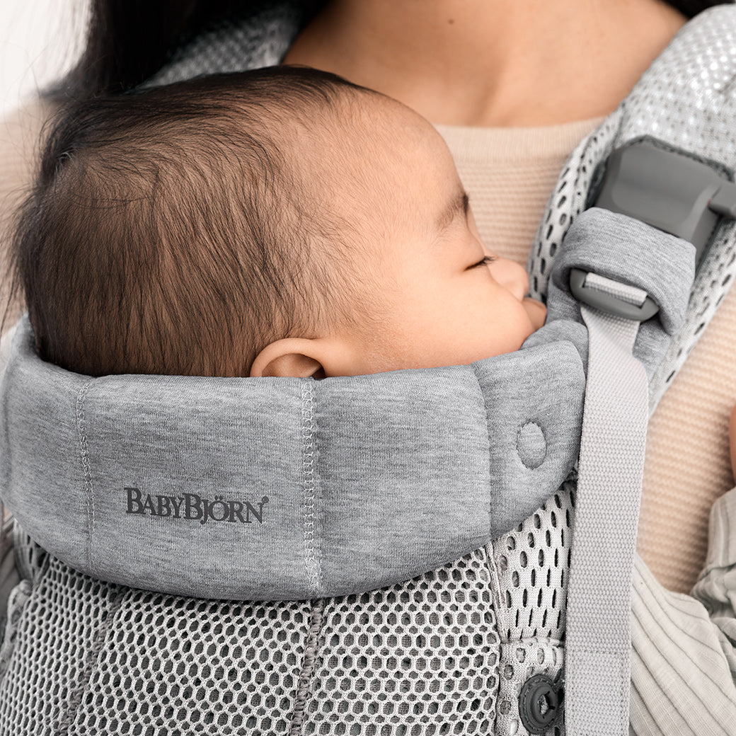Closeup of the top of Babybjorn Baby Carrier Harmony with baby inside in -- Color_Silver