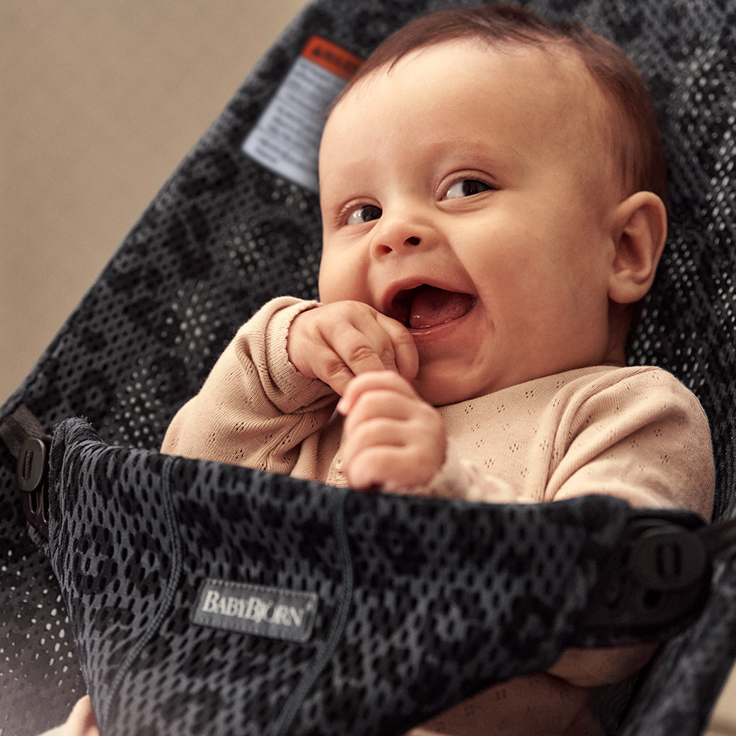 Baby laughing in BABYBJÖRN Bouncer Bliss in -- Color_Anthracite Leopard Mesh