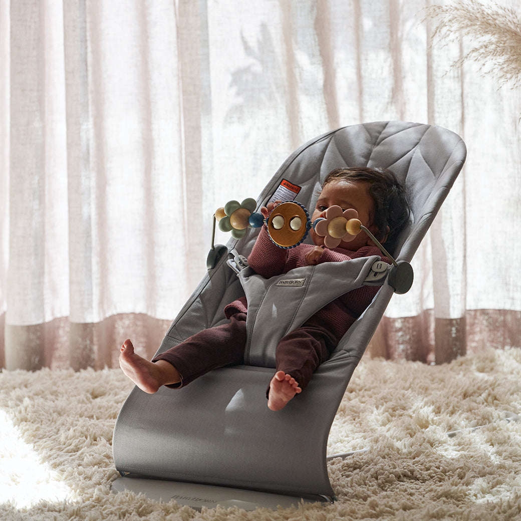 Baby in BABYBJÖRN Bouncer Bliss on a fluffy carpet in -- Color_Light Grey Woven, Petal Quilt