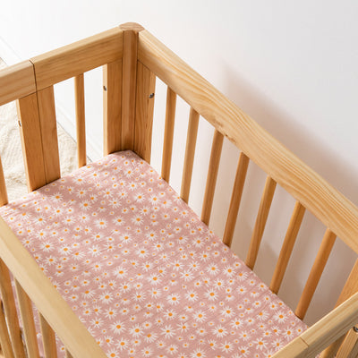 Babyletto All-Stages Bassinet Sheet In GOTS Certified Organic Muslin Cotton in a crib in -- Color_Daisy