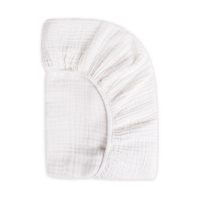 Back view of the corner of the Babyletto's Crib Sheet in GOTS Certified Organic Muslin Cotton in -- Color_White