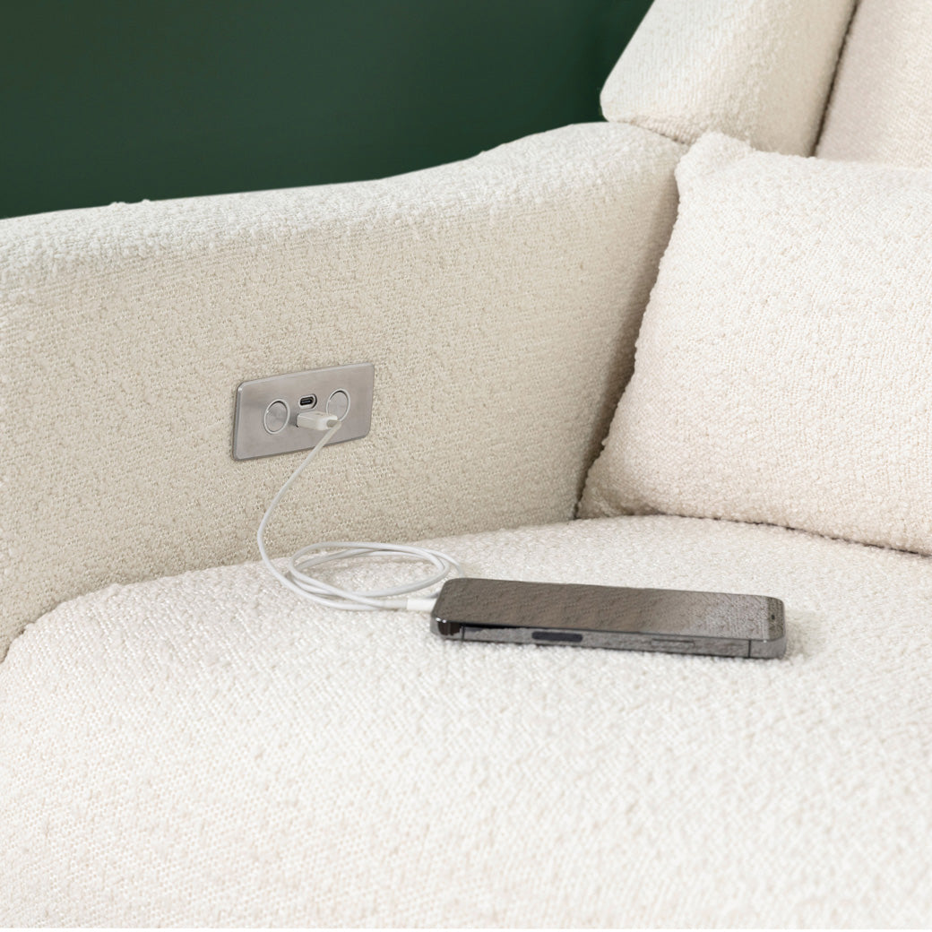 Babyletto Kiwi Glider Recliner closeup of a phone charging on the USB port  in -- Color_Ivory Boucle with Gold Base