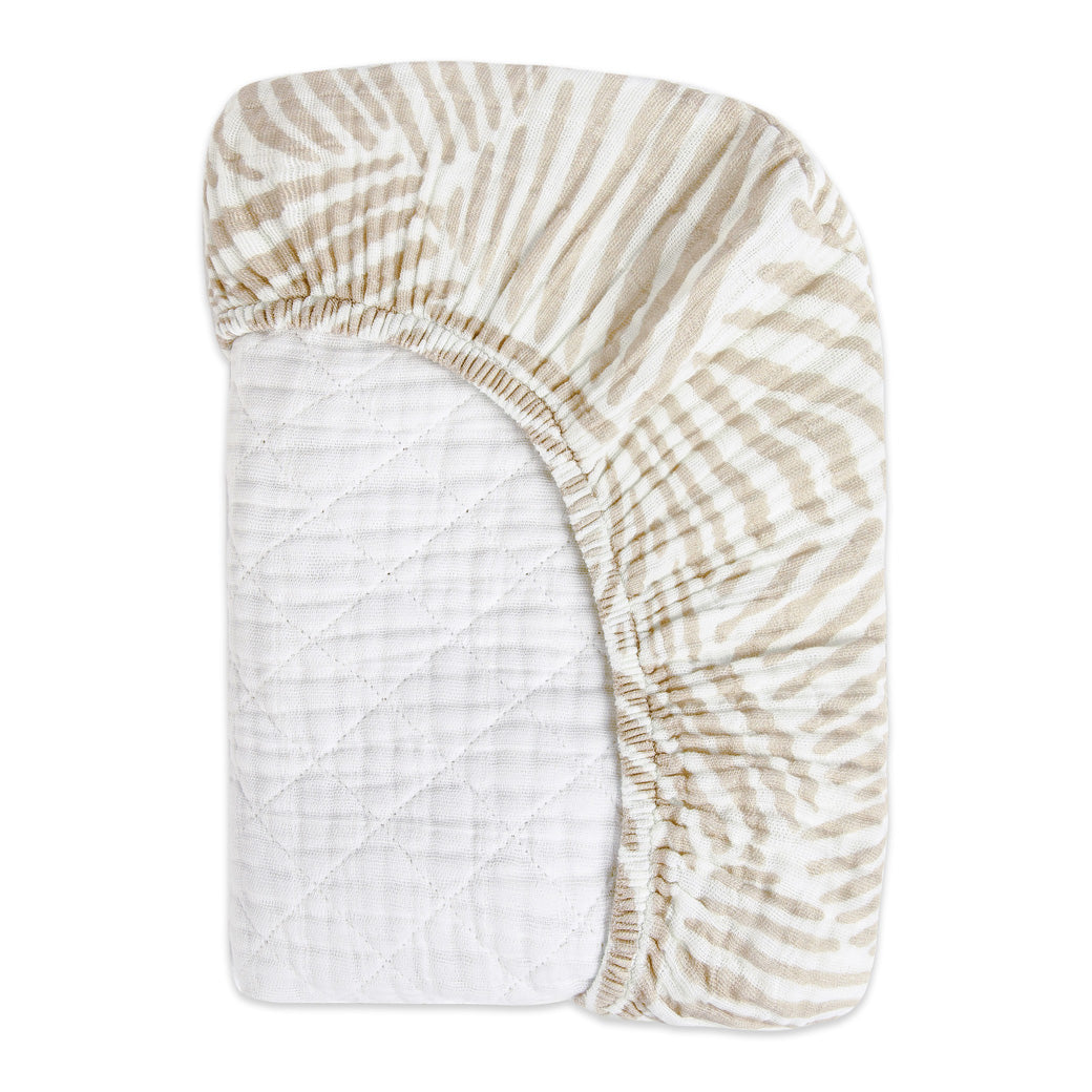 Folded corner of the Babyletto Quilted Changing Pad Cover In GOTS Certified Organic Muslin Cotton in -- Color_Oat Stripe