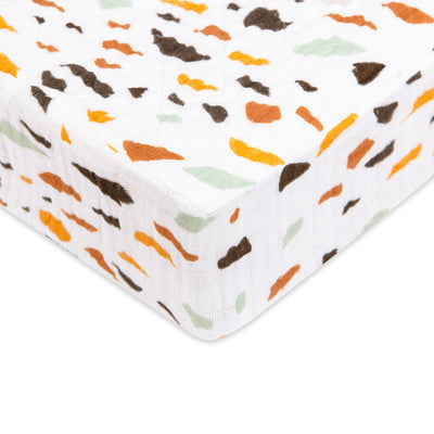 Corner of Babyletto Quilted Changing Pad Cover In GOTS Certified Organic Muslin Cotton in -- Color_Terrazzo