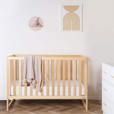 Dadada Austin 3-in-1 Crib with a blanket over the rail  in -- Color_Natural