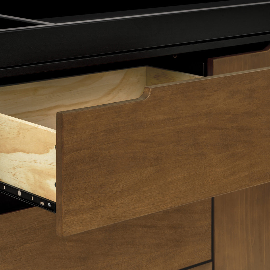 Closeup of open drawer of The Babyletto Hudson Changer Dresser in -- Color_Black/Natural Walnut