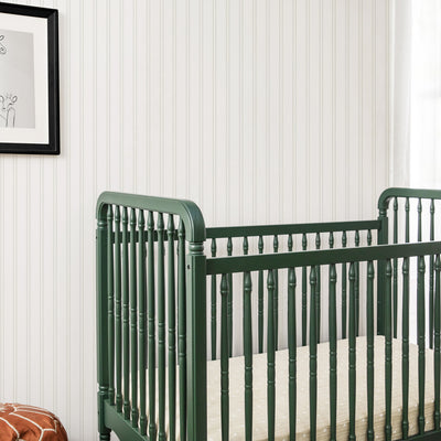 Lifestyle closeup corner view of The Namesake Liberty 3-in-1 Convertible Spindle Crib in -- Color_Forest Green
