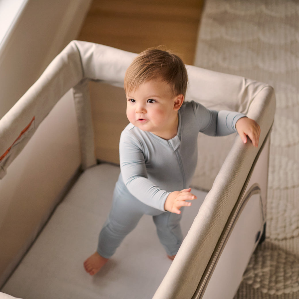 cute child in afternoon glow while in their remi travel crib -- Color_Charlie