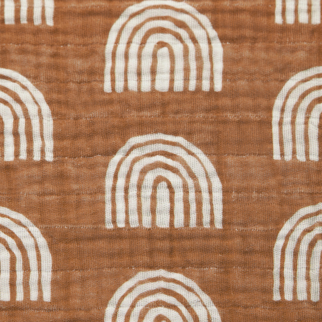 Closeup of pattern of Babyletto's All-Stages Midi Crib Sheet In GOTS Certified Organic Muslin Cotton in -- Color_Terracotta Rainbow