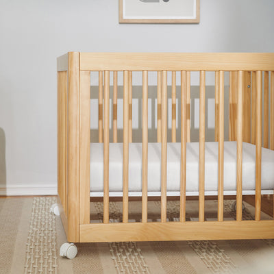 Babyletto's All-Stages Midi Crib Sheet In GOTS Certified Organic Muslin Cotton in a crib in -- Color_White