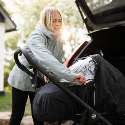Mother zips up the Thule Shine All Weather Cover -- Lifestyle