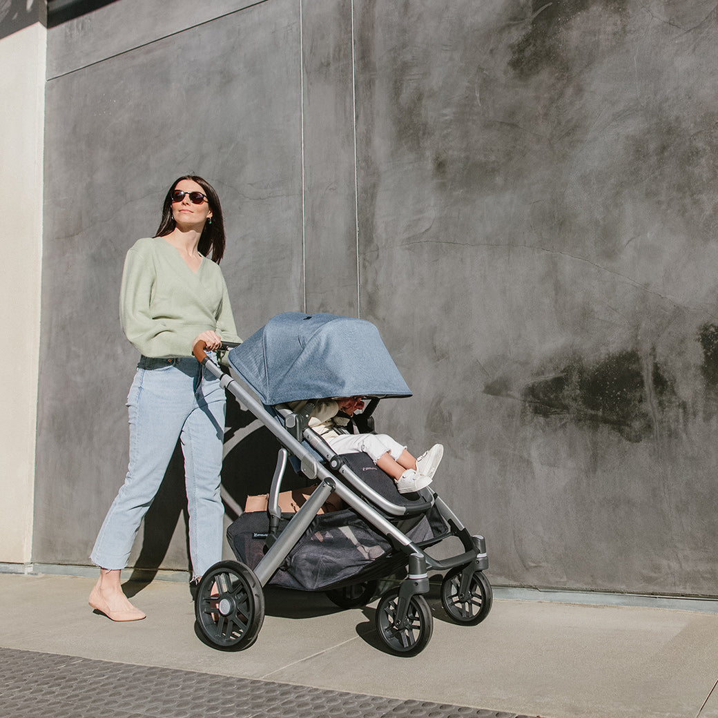 Women with sunglasses pushing extended sunshade on the vista v2 stroller  -- Color_Gregory