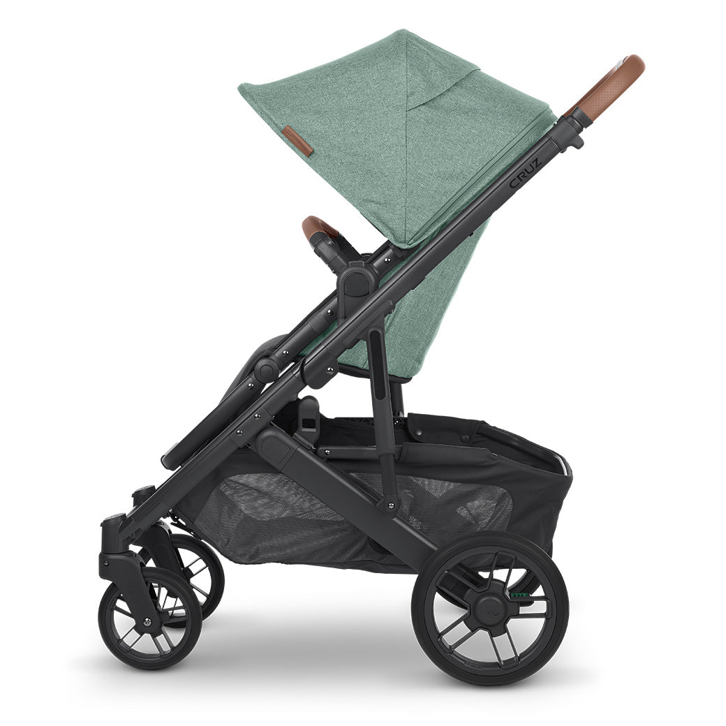 A side view of UPPAbaby CRUZ V2 Stroller with black frame and matcha green fabric -- Color_Gwen
