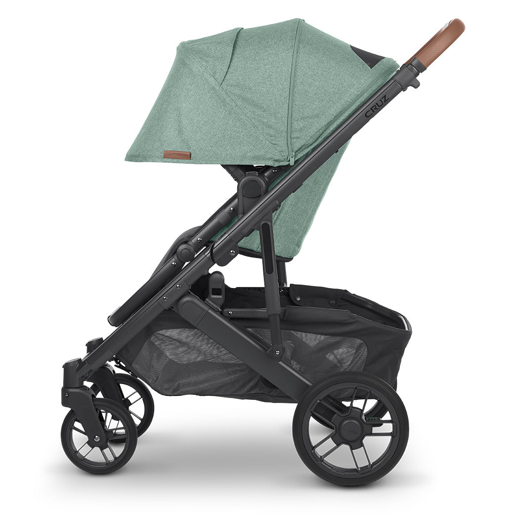 A side view of UPPAbaby CRUZ V2 Stroller with green shade extended -- Color_Gwen