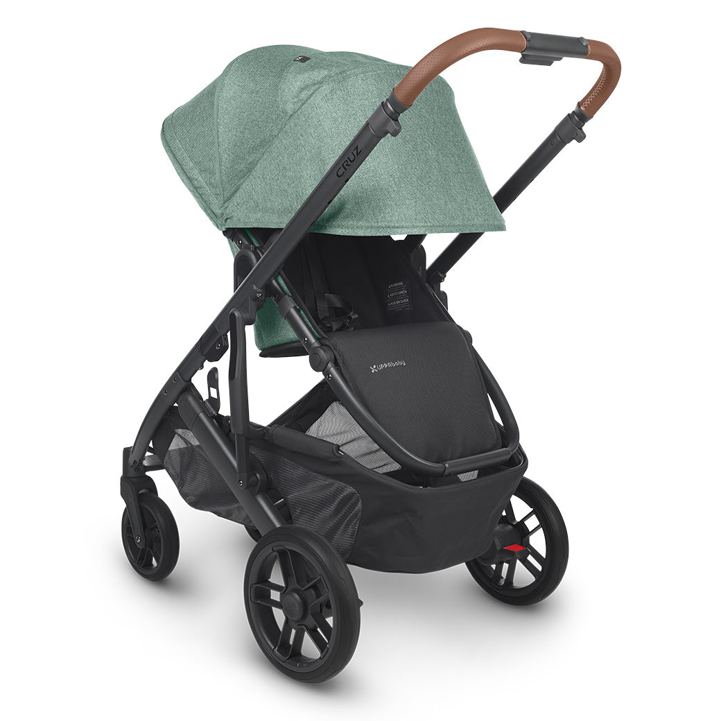 UPPAbaby CRUZ V2 Stroller basket facing the same way as the handle with the shade down in green -- Color_Gwen