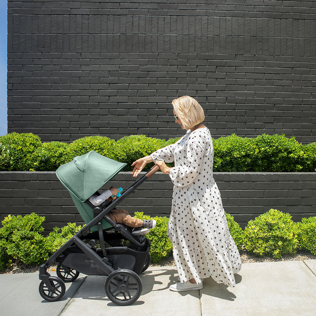 woman standing in front of the vista v2 stroller in Jake while looking at child in stroller -- Color_Gwen